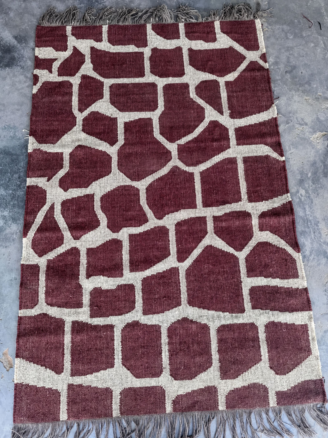 a red and white patterned rug with a giraffe print design.