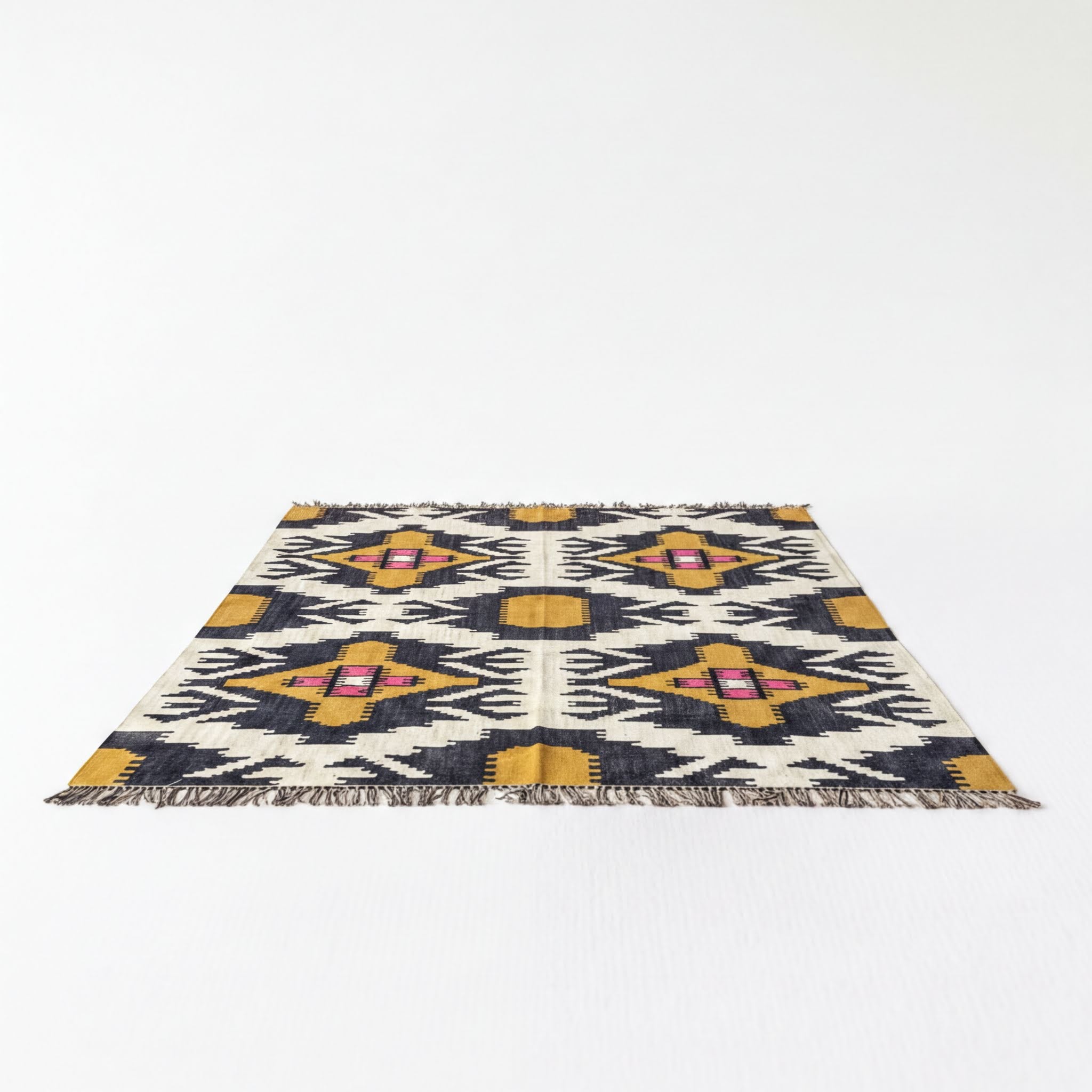 a rug with a geometric pattern in shades of yellow, black, and white.