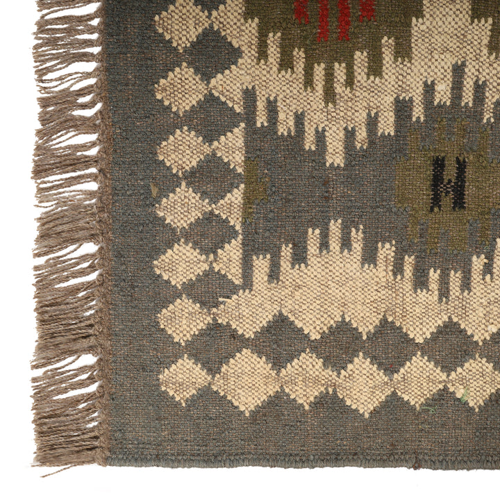 Kilim wool jute rug, handwoven with a tribal geometric pattern and fringe