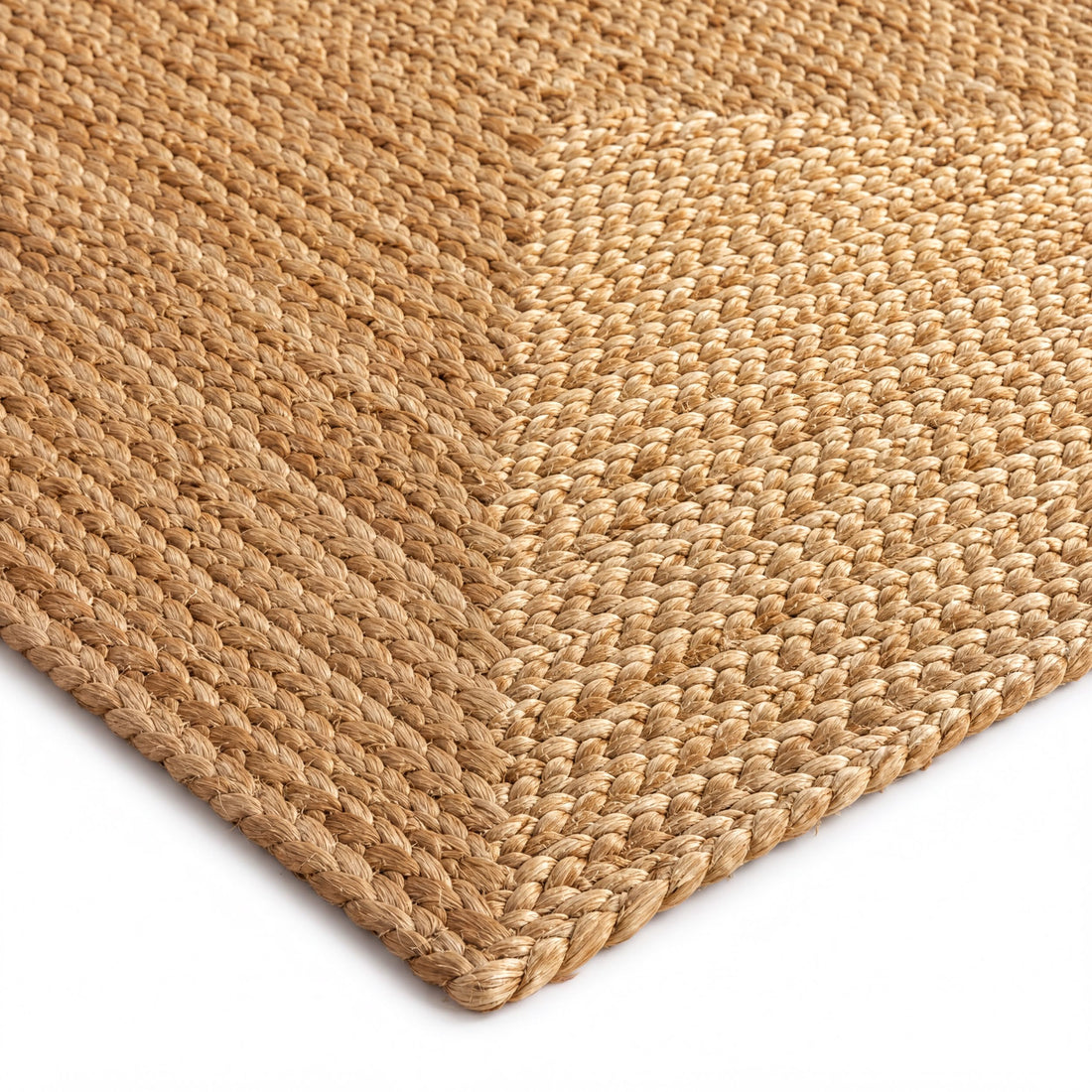 a close-up view of a woven, textured area rug with a woven pattern.