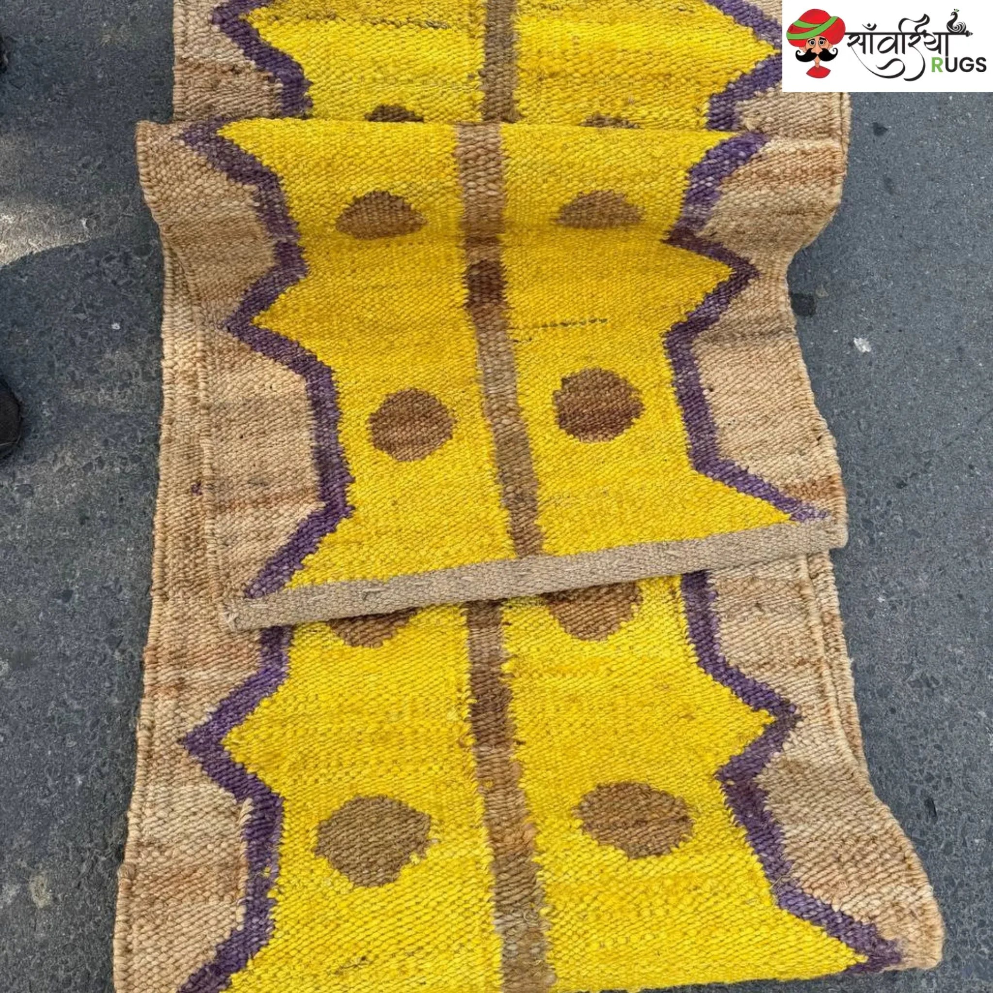 Yellow jute runner rug with geometric brown and purple pattern